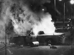 The meme is a humorous image of a car on fire, with flames engulfing the vehicle and smoke billowing into the air. The text "I just got my first car" is written in a playful, sarcastic tone, implying that the owner's new vehicle is already meeting its demise. The image is a relatable and comedic take on the frustrations of car ownership.